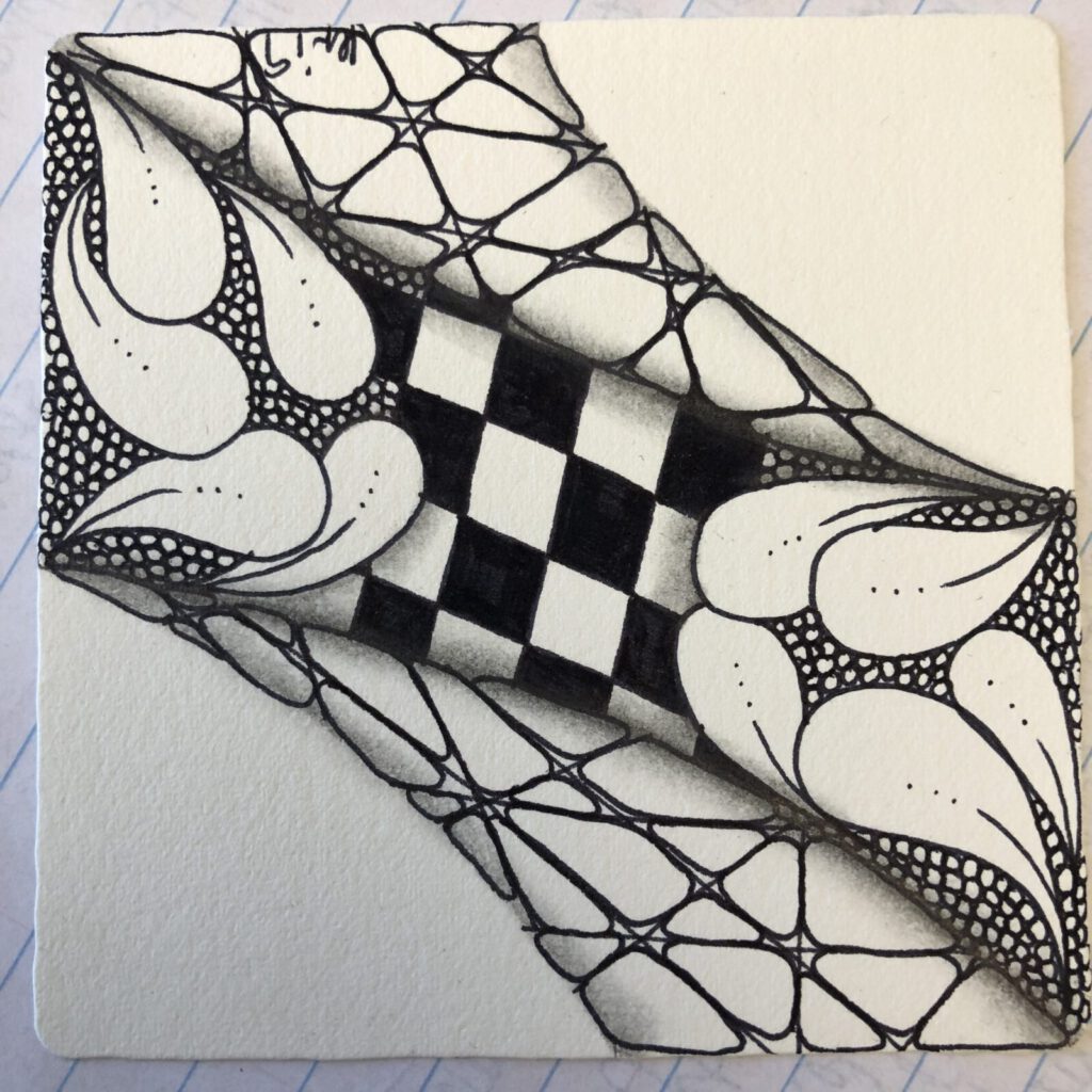 A large Zentangle tile combining checkerboard and fan patterns in black ink